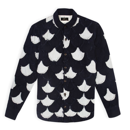A navy and light blue denim jacket with scalloped patchwork pattern and eyelash fringe detailing.