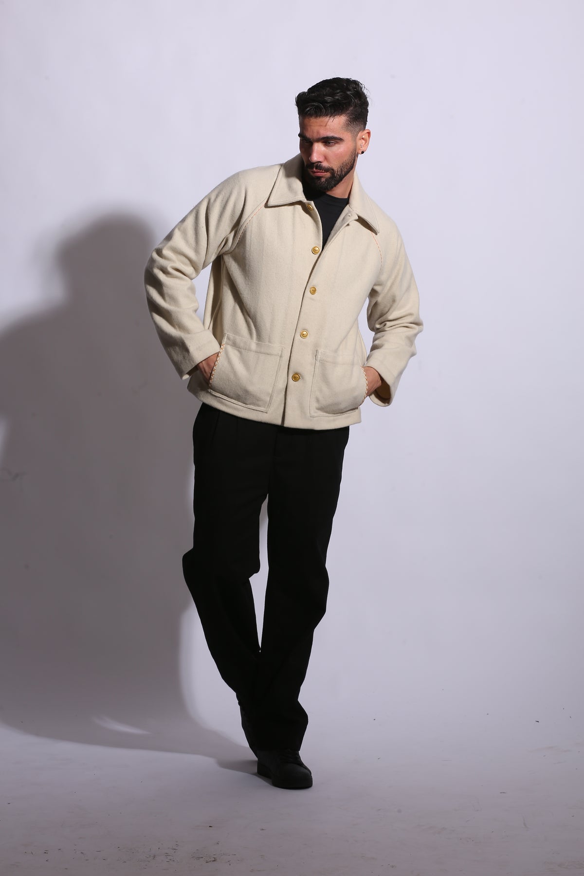 Man wearing a beige trench coat on a white background