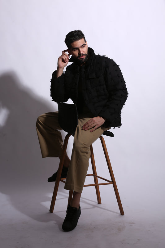 Person sitting on a stool with a white background