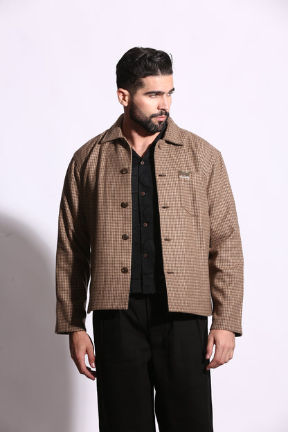 Man wearing a brown checkered suit jacket on a white background