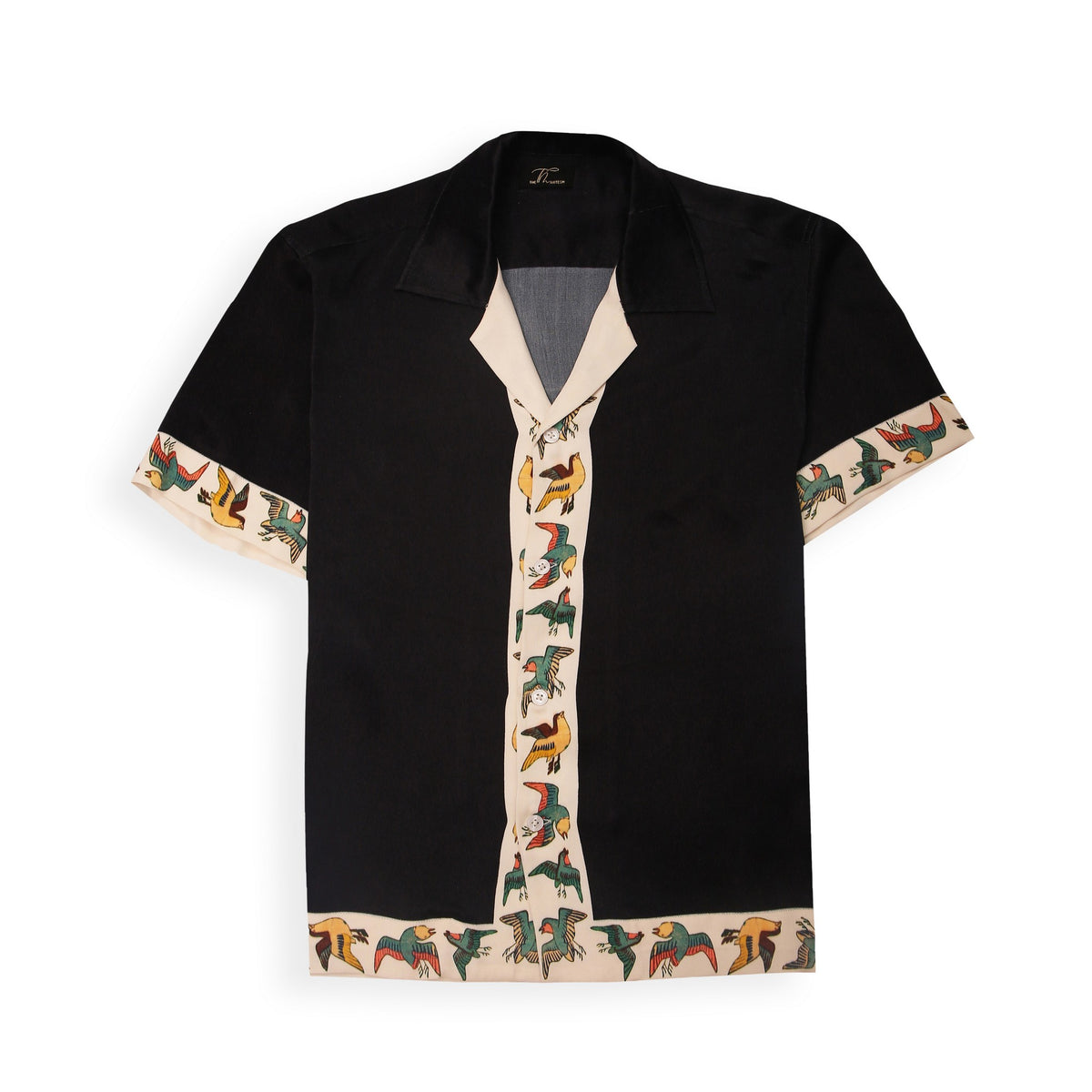 A black shirt with a vibrant bird of paradise pattern on the collar and sleeves, displayed against a white background.