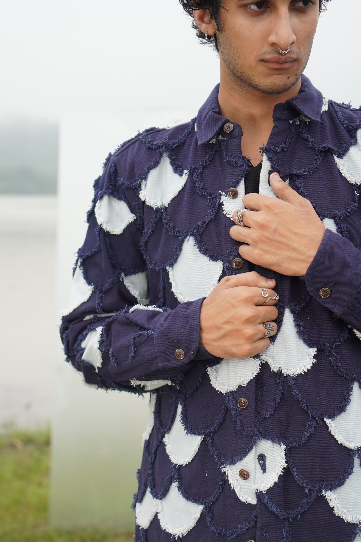A picture of the Arden Unisex Denim Jacket with eyelash fringe from the front. It reads, 
"Unisex denim jacket with patchwork design and handmade eyelash fringe" and "Arden 
denim jacket in light blue and navy with fringe details."