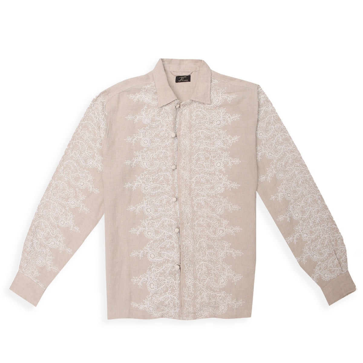 A beige linen shirt with intricate corded embroidery spread across the surface.