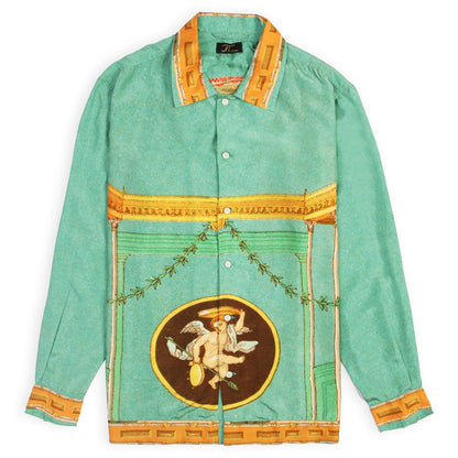A green silk shirt with a detailed festive print, including a central graphic with a bird and surrounding decorative elements, with a collar and button-up front.